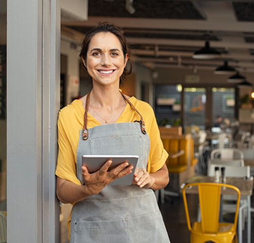 Business owner smiling holding a tablet