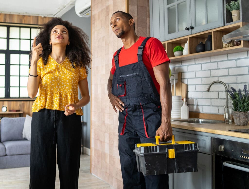 Women showing the damage she needs repaired to a restoration service professional