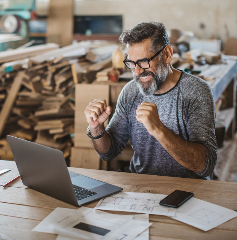 Business owner excited after seeing his businesses reviews and preparing to respond back to them