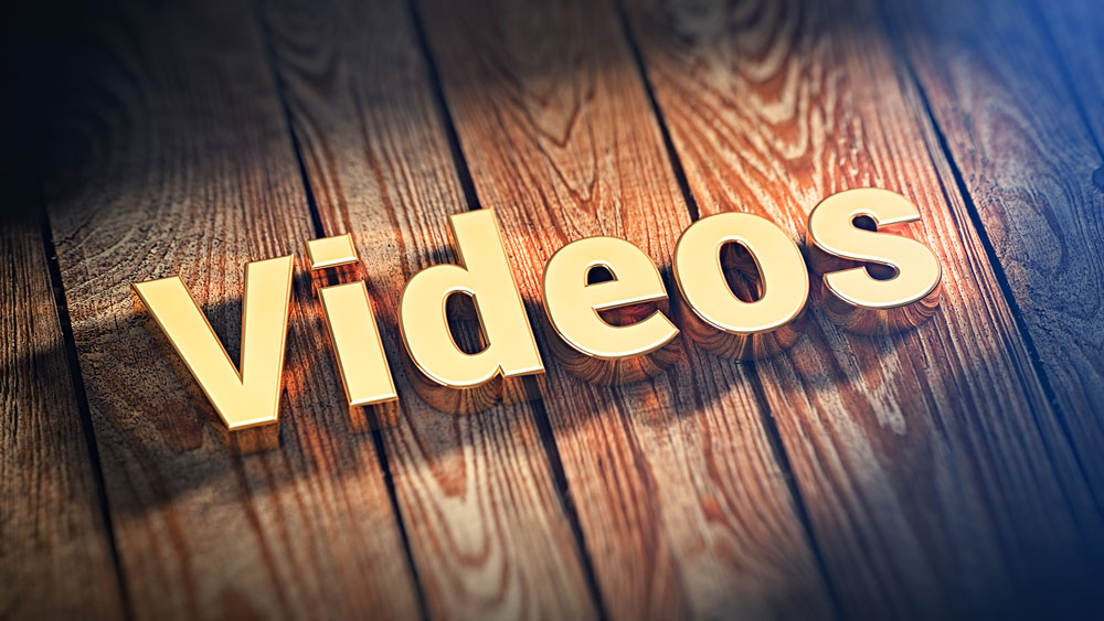 The word "Videos" is lined with gold letters on wooden planks