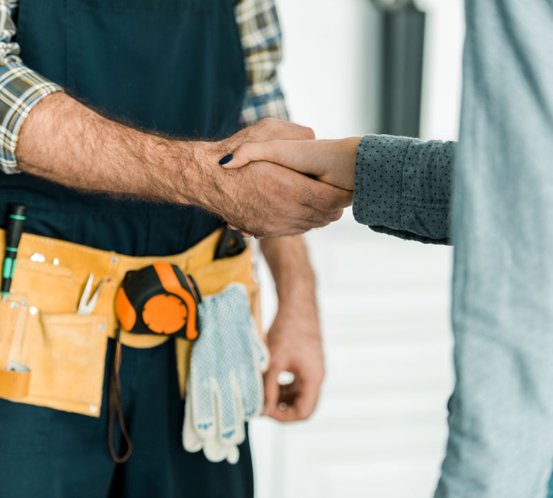 Image of a plumber shacking hands with their customer