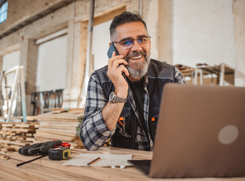 Home Service Business owner on the phone with ZipLocal go over his monthly sync up and looking happy with the progress