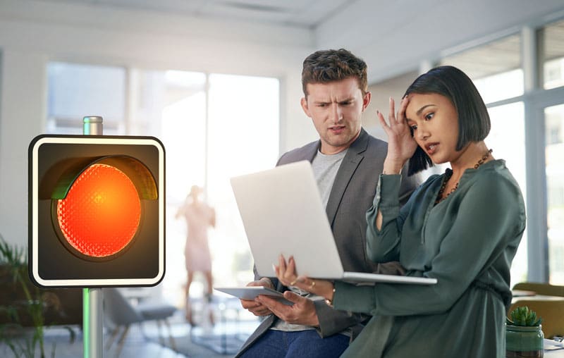 2 Business owners looking at their suspended google business listing with a red light overlapping the image