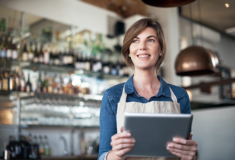 Woman business owner holding a tablet